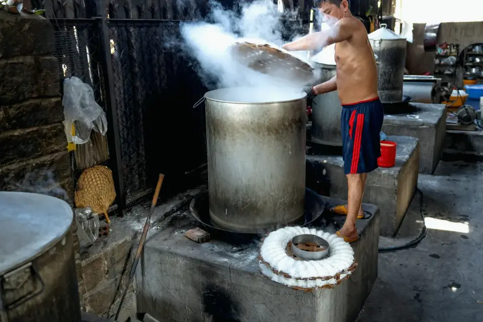 A large, deep-chested dog eating slowly from a ridged slow feeder bowl