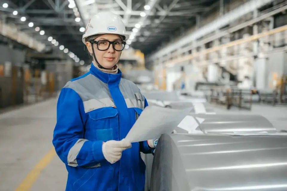 A quality control technician inspecting bottles on a supplement production line