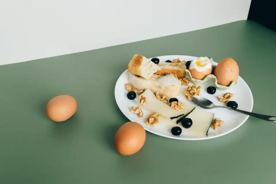 A sliced hard-boiled egg placed beside a dog&#x27;s food bowl