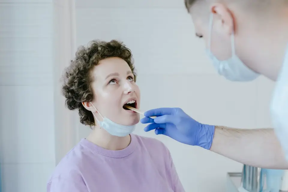 A veterinarian checking a dog&#x27;s gum color during an exam