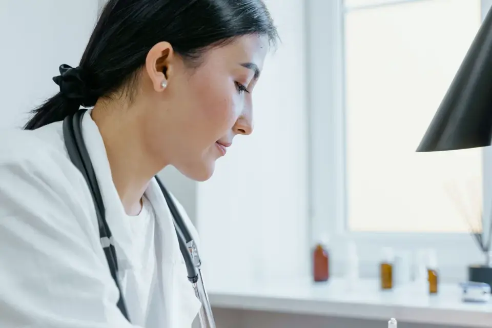 A veterinarian examining the ingredient label on a dog supplement bottle