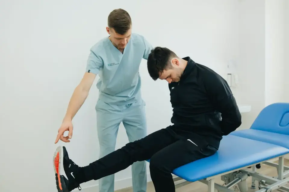 A veterinarian gently checking a dog&#x27;s hip mobility during an exam