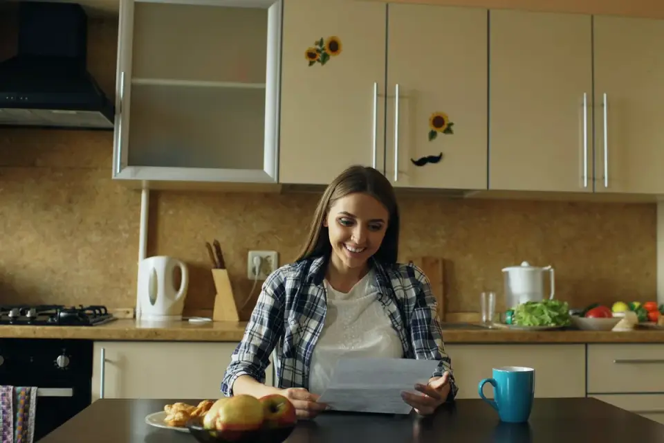 Dog owner reading a supplement ingredient label at a kitchen counter