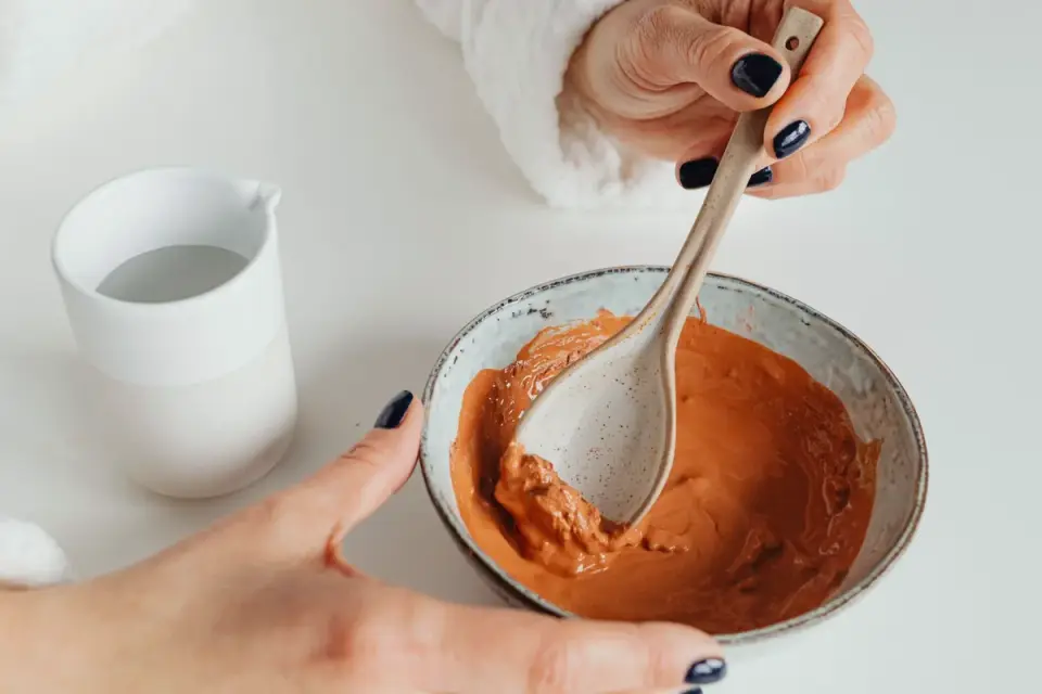 Supplement powder being stirred into a bowl of wet dog food