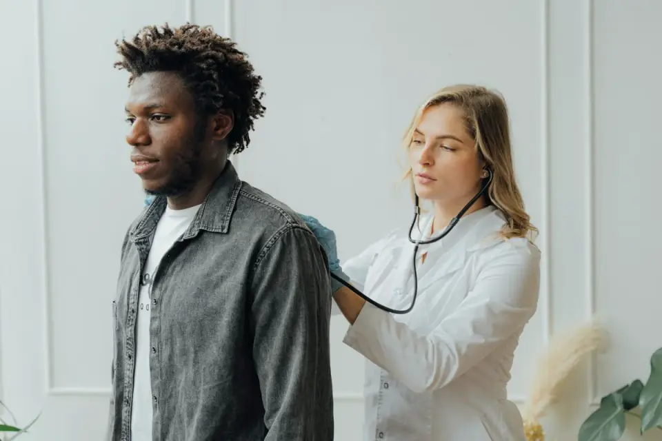 Veterinarian using a stethoscope to listen to a senior dog&#x27;s heart during an exam